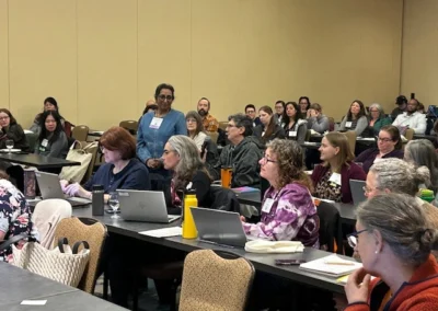 Oregon Geriatrics Society 2025 Conference - numerous attendees seated - some of whom have laptops they are working at